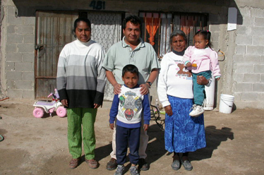 Priscilliano & Rosalinas Family standing for the camera outside their home