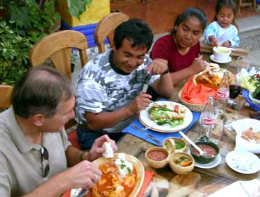 Sitting with the Prisciliano family and having local foods