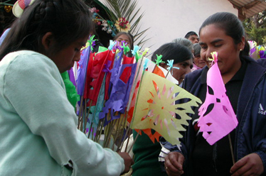 Villagers giving traditional handmade paper flags during celebration