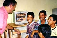 boys talking in classroom setting with computer