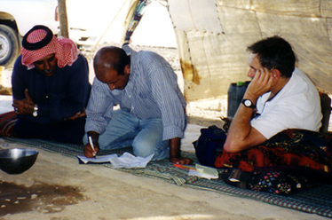 Patrick & Mohammed Al-Oun sitting in tent