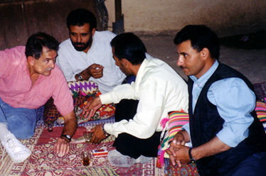 Patrick and local men talking and relaxing with sweet tea